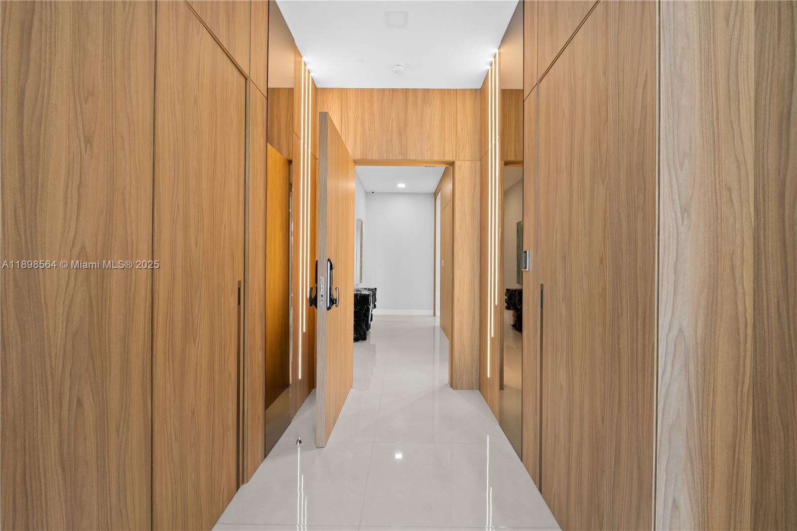 1530 Island Boulevard Aventura, FL 33160 - Photo 44 of 99 a view of a hallway with a wooden door