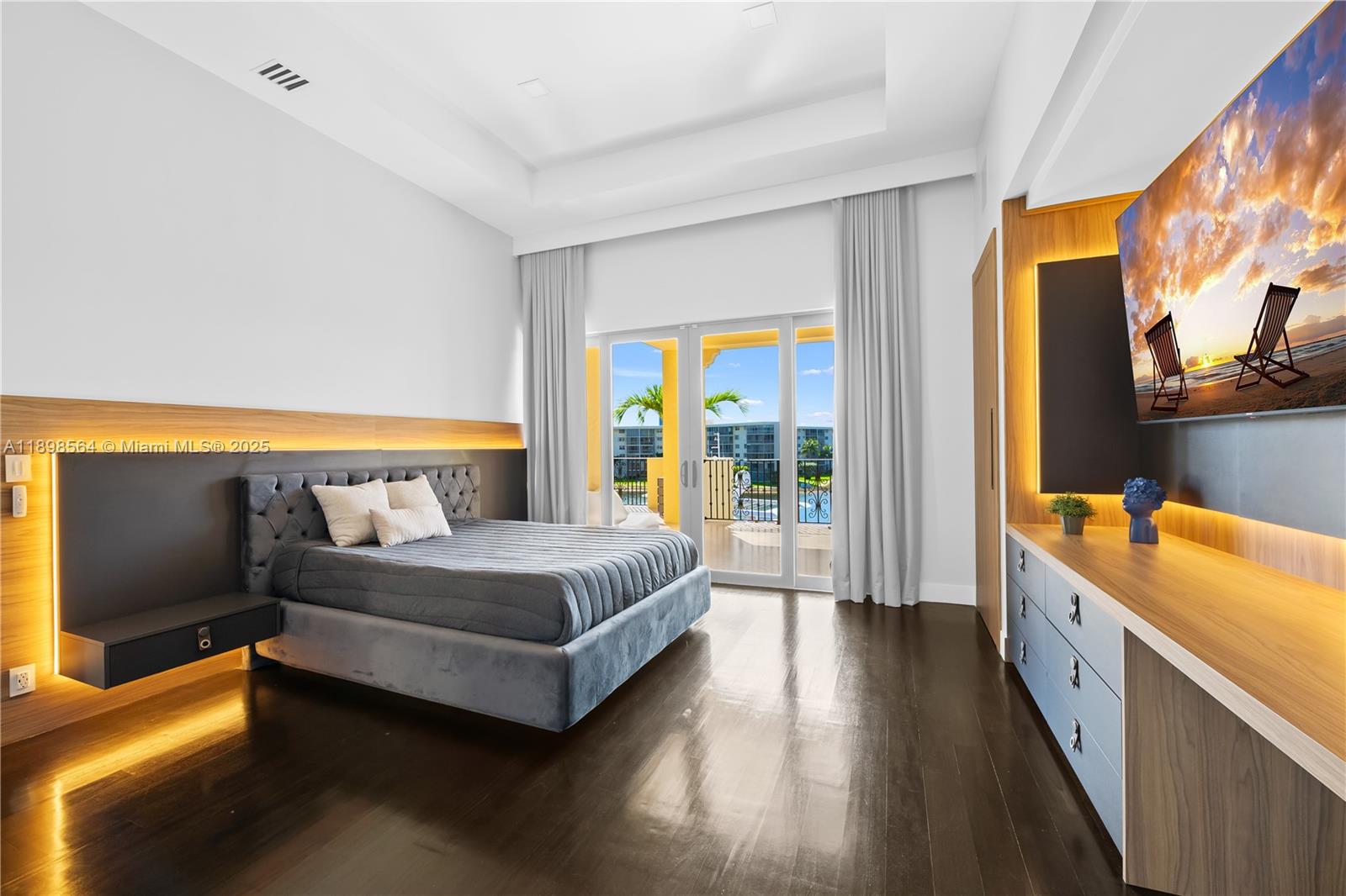 1530 Island Boulevard Aventura, FL 33160 - Photo 57 of 99 a spacious bedroom with a bed and a dresser next to a window