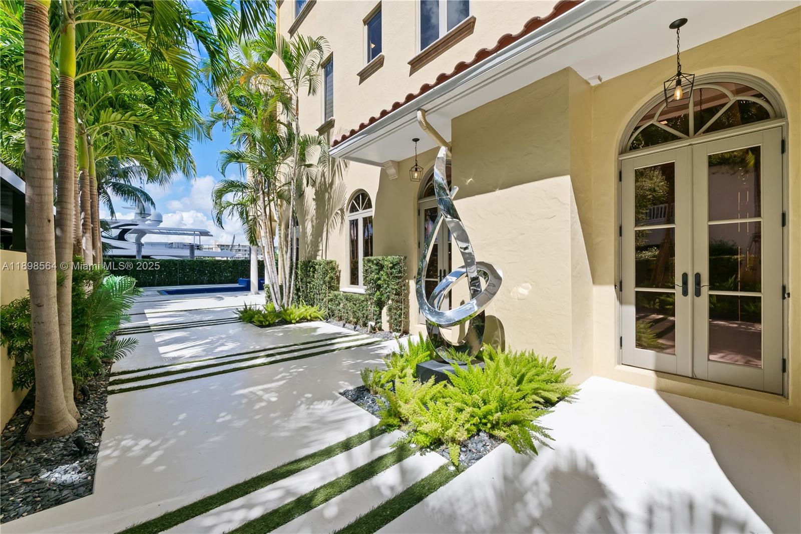 1530 Island Boulevard Aventura, FL 33160 - Photo 79 of 99 a front view of a house with a yard