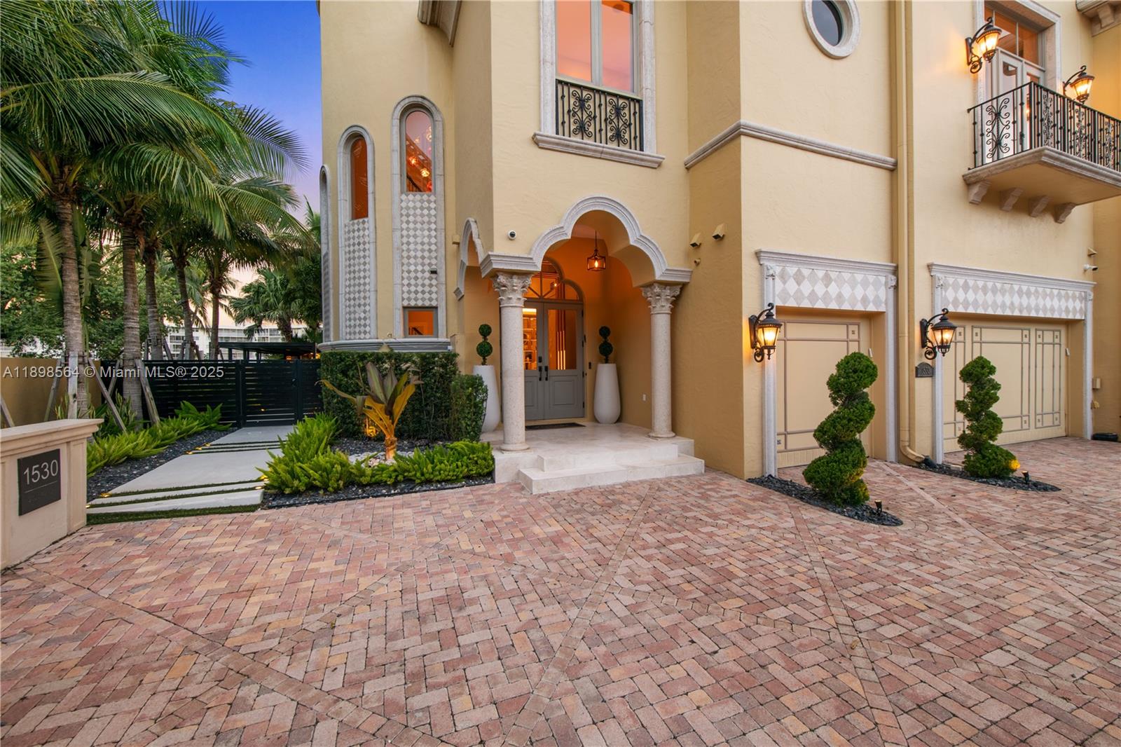 1530 Island Boulevard Aventura, FL 33160 - Photo 94 of 99 a front view of a house with garden