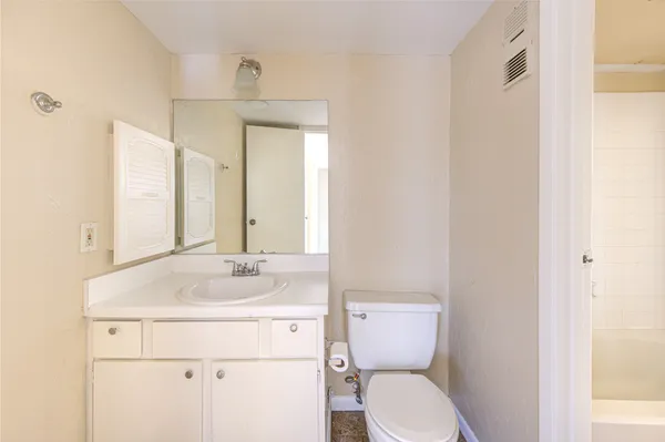 a bathroom with a sink toilet and mirror