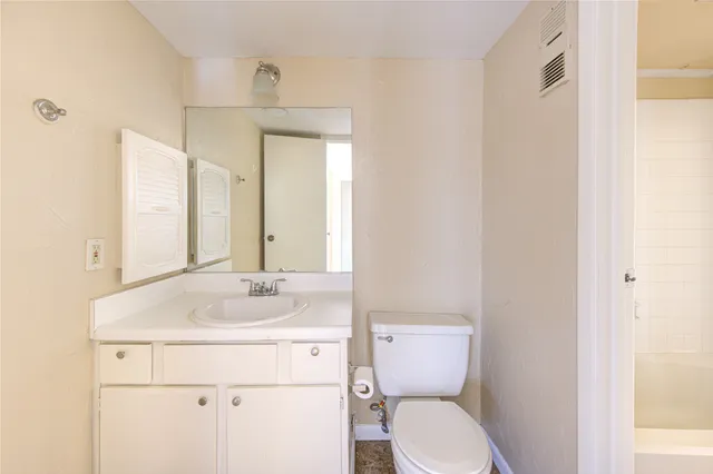 a bathroom with a sink toilet and mirror