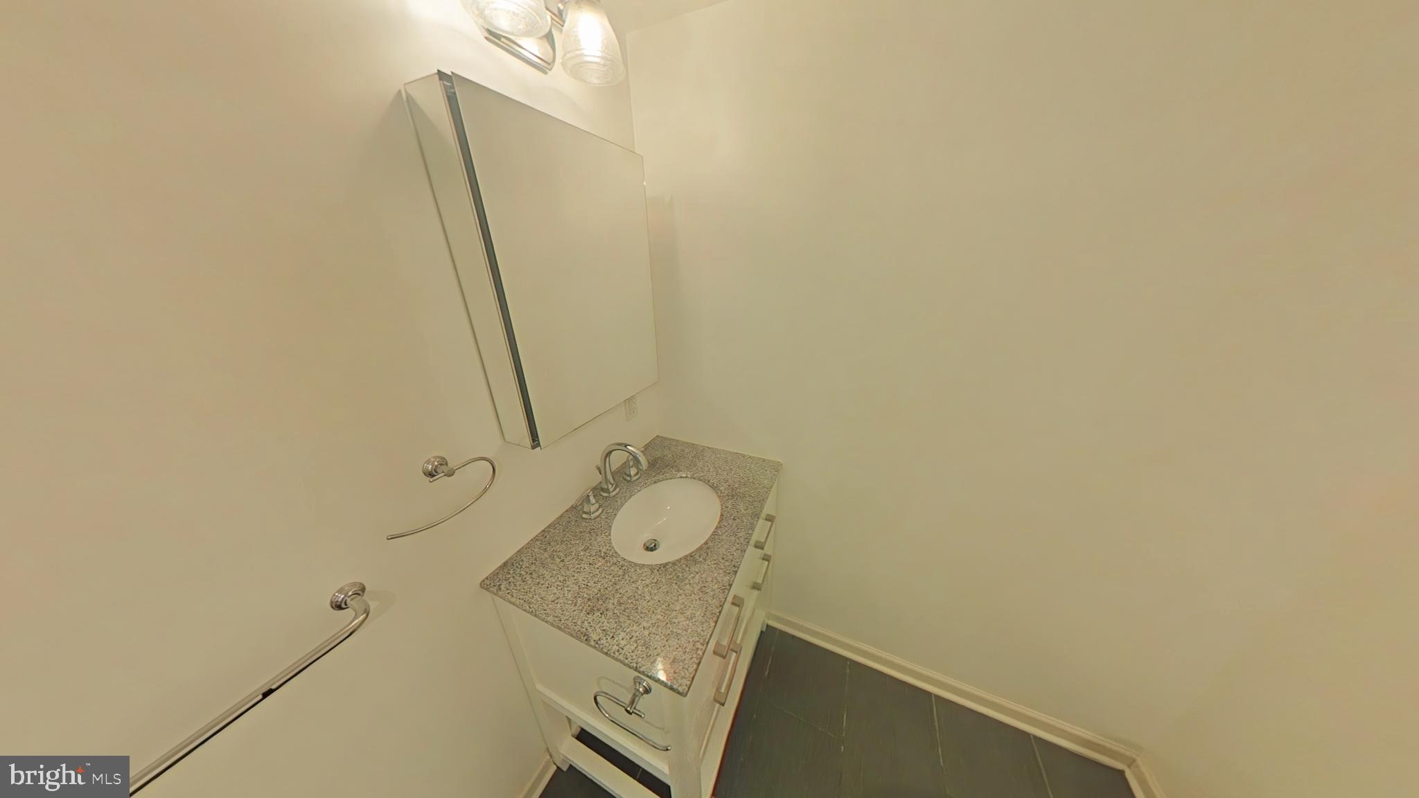 4539 Mitchell Street, Unit 202 Philadelphia, PA 19128 - Photo 5 of 7 a bathroom with a sink and vanity