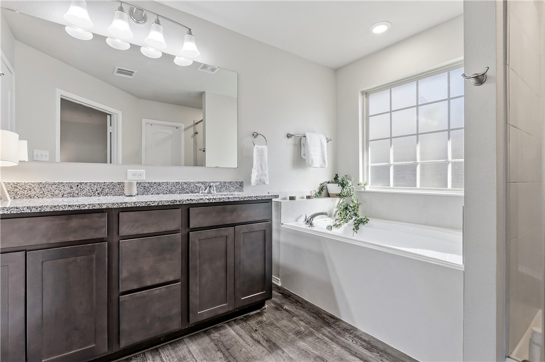 2721 Porter's Way Bryan, TX 77803 - Photo 14 of 17 Primary bath with garden tub, separate shower, granite countertop & toilet closet