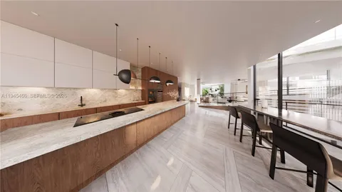 a kitchen with stainless steel appliances granite countertop sink stove and white cabinets with wooden floor