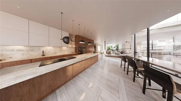 a kitchen with stainless steel appliances granite countertop sink stove and white cabinets with wooden floor