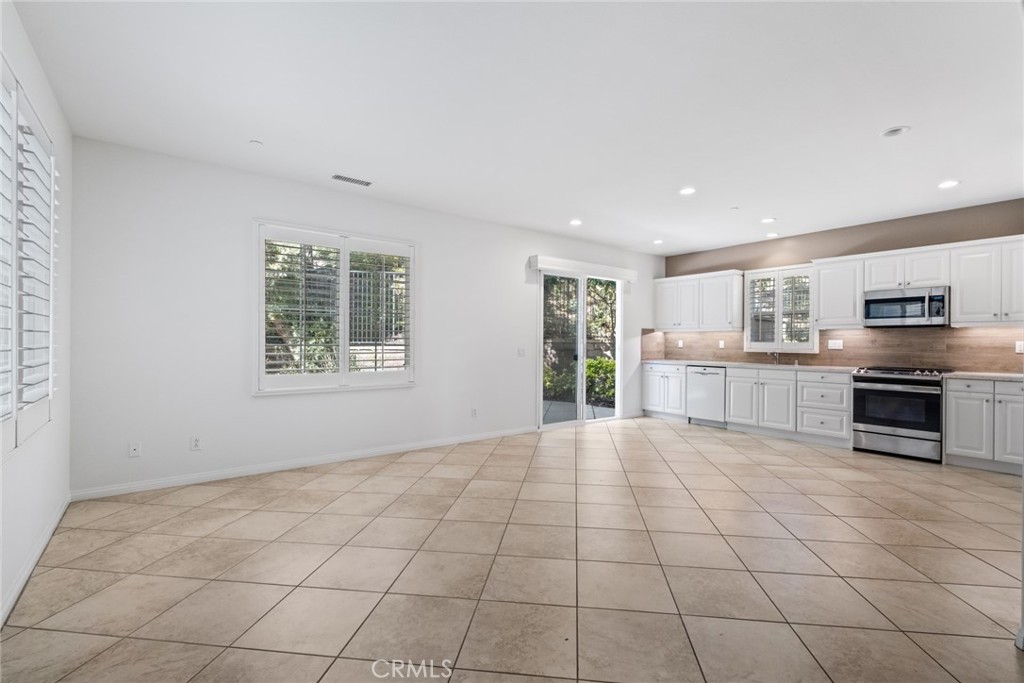 61 Bellwind Irvine, CA 92603 - Photo 4 of 22 a view of a kitchen with microwave and windows