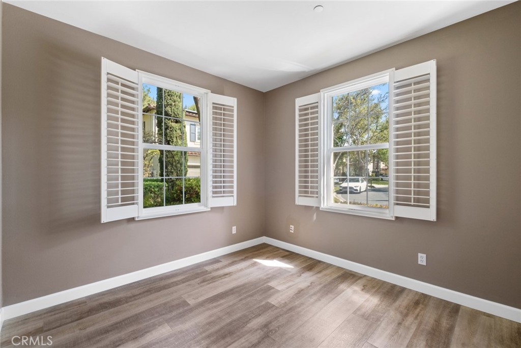 61 Bellwind Irvine, CA 92603 - Photo 8 of 22 a view of an empty room with wooden floor and a window