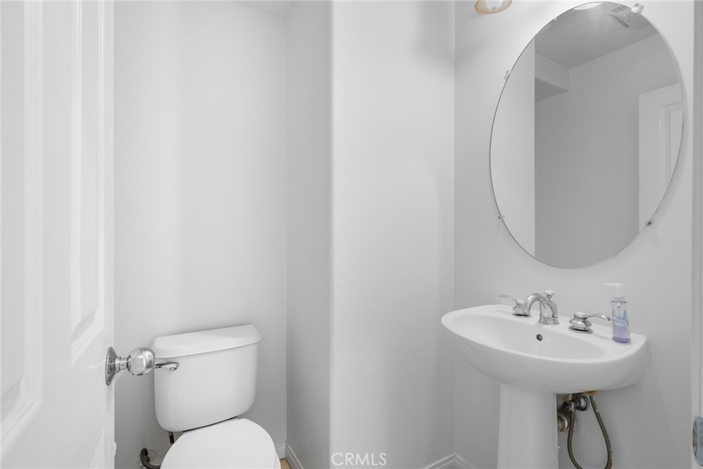 61 Bellwind Irvine, CA 92603 - Photo 9 of 22 a bathroom with a toilet sink and mirror