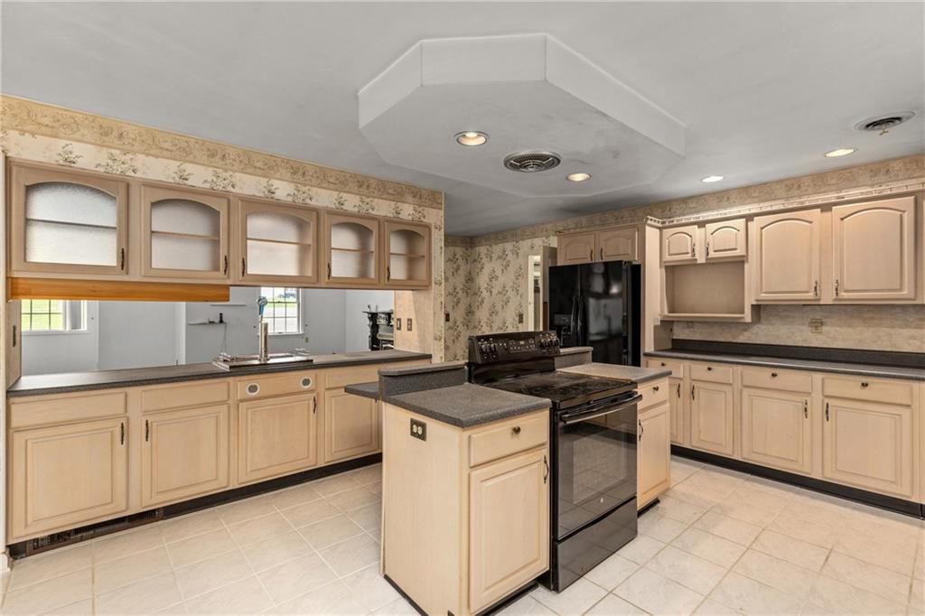 9260 Lakeview Drive Irwin, PA 15642 - Photo 14 of 47 a kitchen with stainless steel appliances granite countertop a stove sink and cabinets