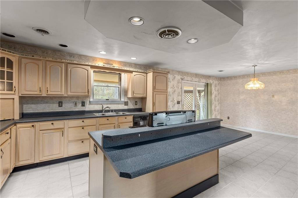 9260 Lakeview Drive Irwin, PA 15642 - Photo 16 of 47 a kitchen with granite countertop a sink and white cabinets