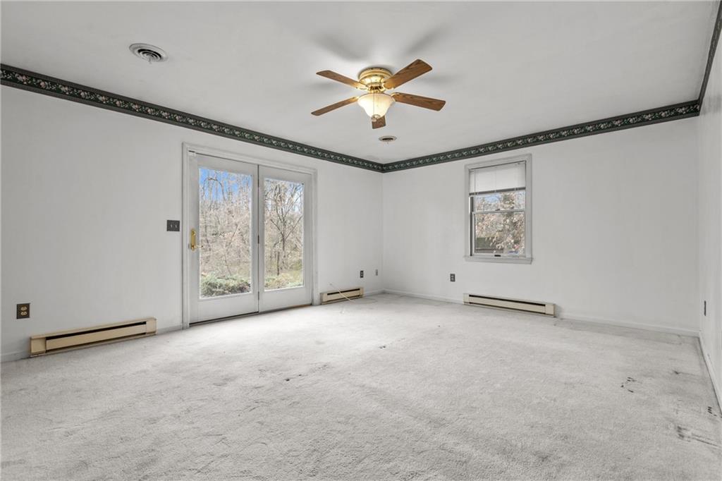9260 Lakeview Drive Irwin, PA 15642 - Photo 19 of 47 an empty room with windows and fan