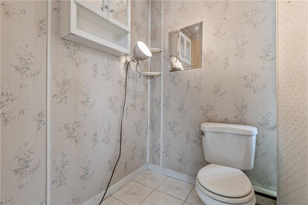 9260 Lakeview Drive Irwin, PA 15642 - Photo 30 of 47 a white toilet sitting next to a bathroom sink