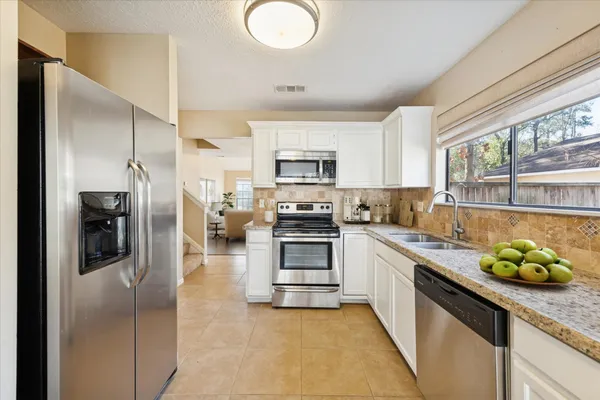 a kitchen with a sink stainless steel appliances and cabinets