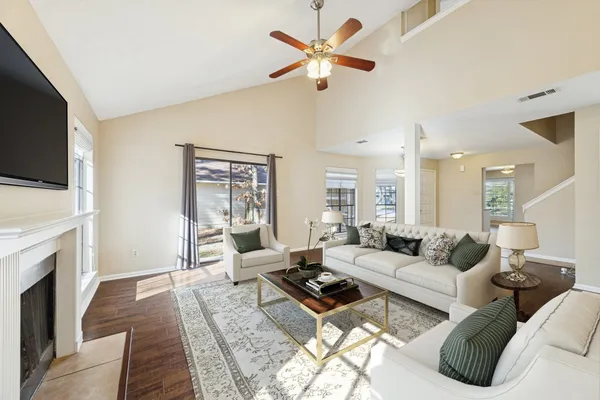 a living room with fireplace furniture and a flat screen tv