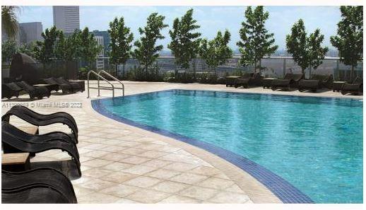 Downtown Miami Miami, FL 33132 - Photo 14 of 17 a view of a swimming pool with chairs and wooden fence