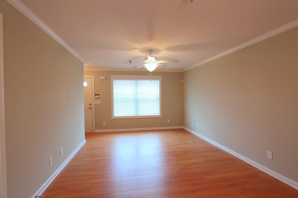 232 Epps Bridge Road, Unit 1A Athens, GA 30606 - Photo 12 of 14 wooden floor in an empty room with a window