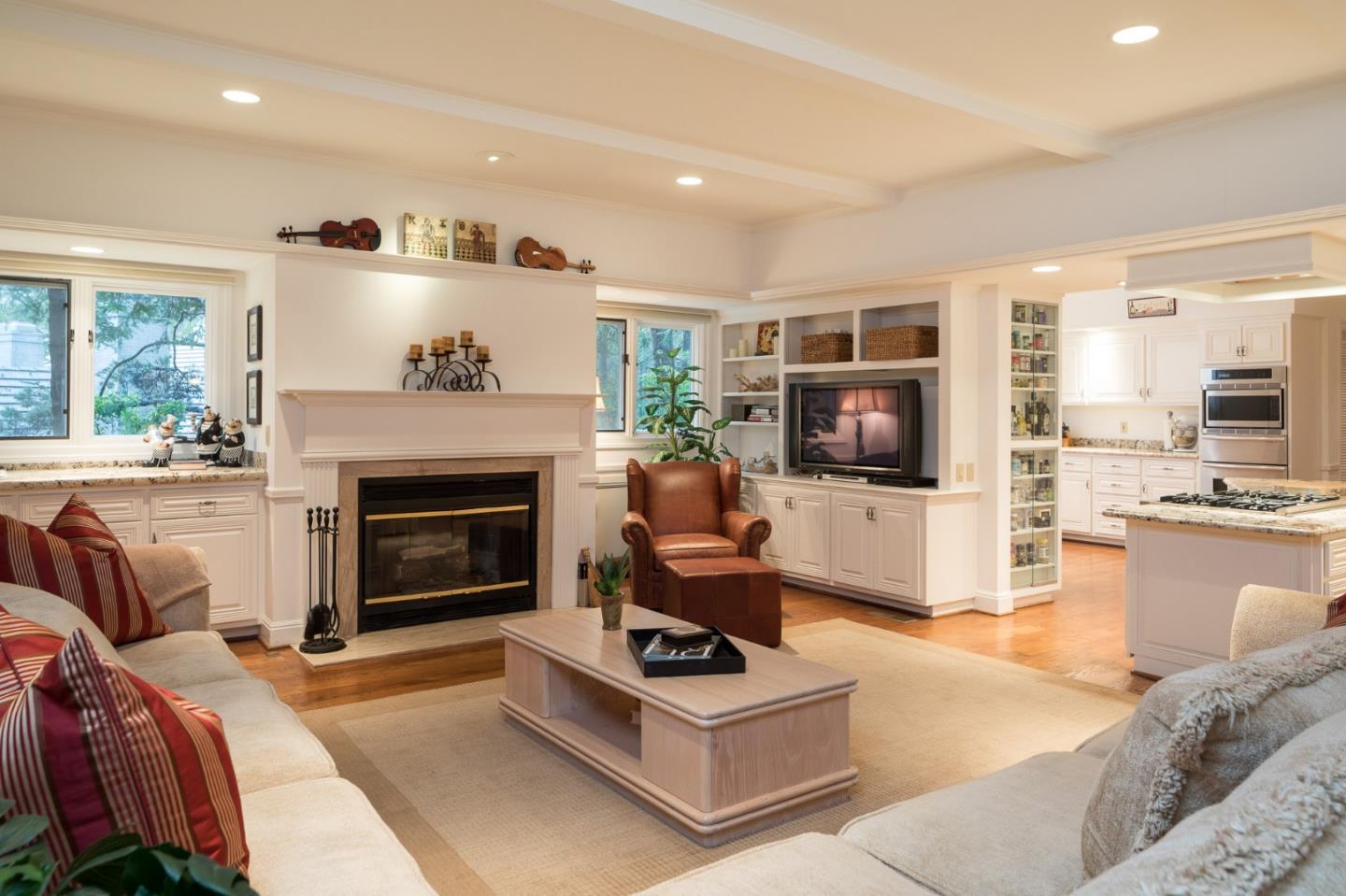 3978 Ronda Road Pebble Beach, CA 93953 - Photo 3 of 20 a living room with furniture a flat screen tv and a fireplace