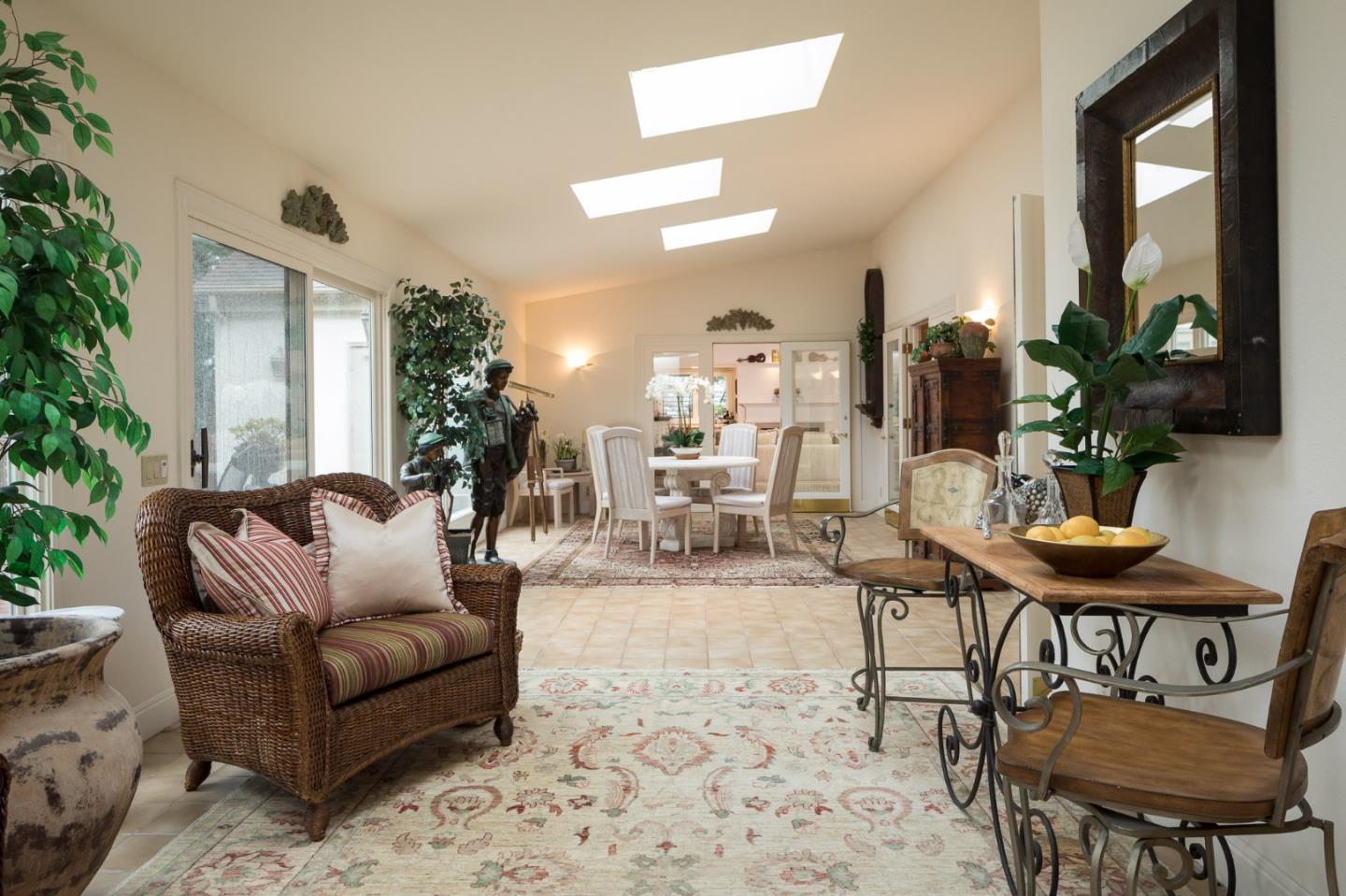 3978 Ronda Road Pebble Beach, CA 93953 - Photo 7 of 20 a living room with furniture a large window and a potted plant