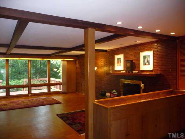 924 Lake Boone Trail Raleigh, NC 27607 - Photo 4 of 12 Red oak-veneer paneling and parquet floors create warm spaces inside while live red oak trees offer shade outside. The copper-lined planter box helps demark the living room. Living Room
