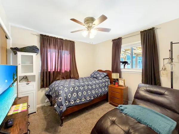 a bedroom with a bed and a chandelier