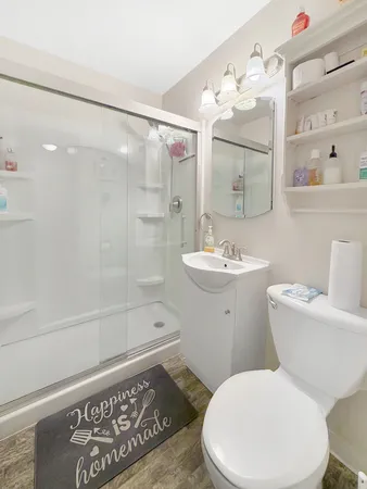 a white toilet sitting next to a bathroom sink