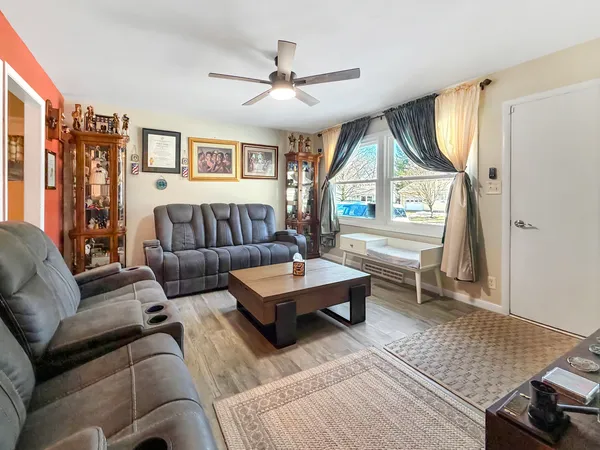 a living room with furniture a table and a large window