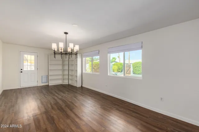 a kitchen with a sink window and cabinets