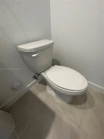a white toilet sitting next to a bathroom sink