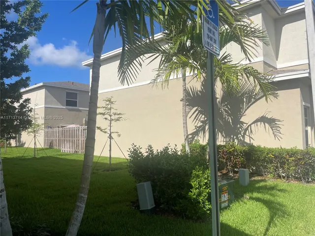 a backyard of a house with a garden and outdoor seating