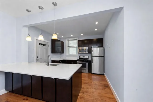 a kitchen with stainless steel appliances a sink stove and refrigerator