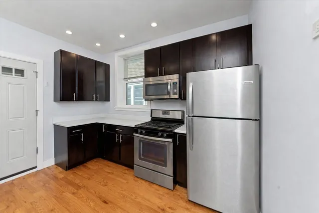 a kitchen with a refrigerator sink and stove top oven