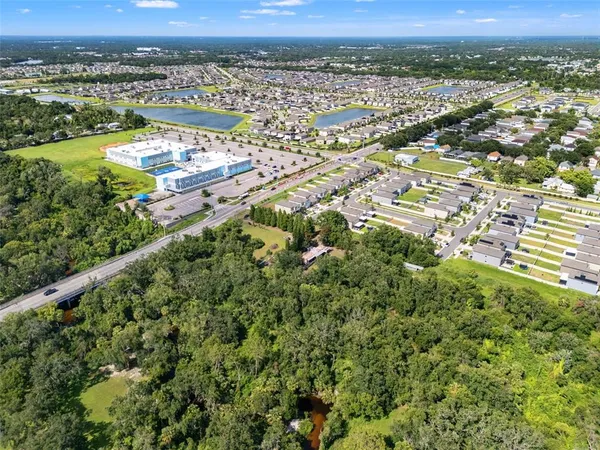 an aerial view of residential houses with outdoor space and river