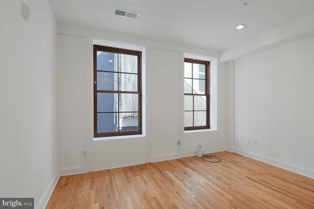 a view of a room with wooden floor and bathroom