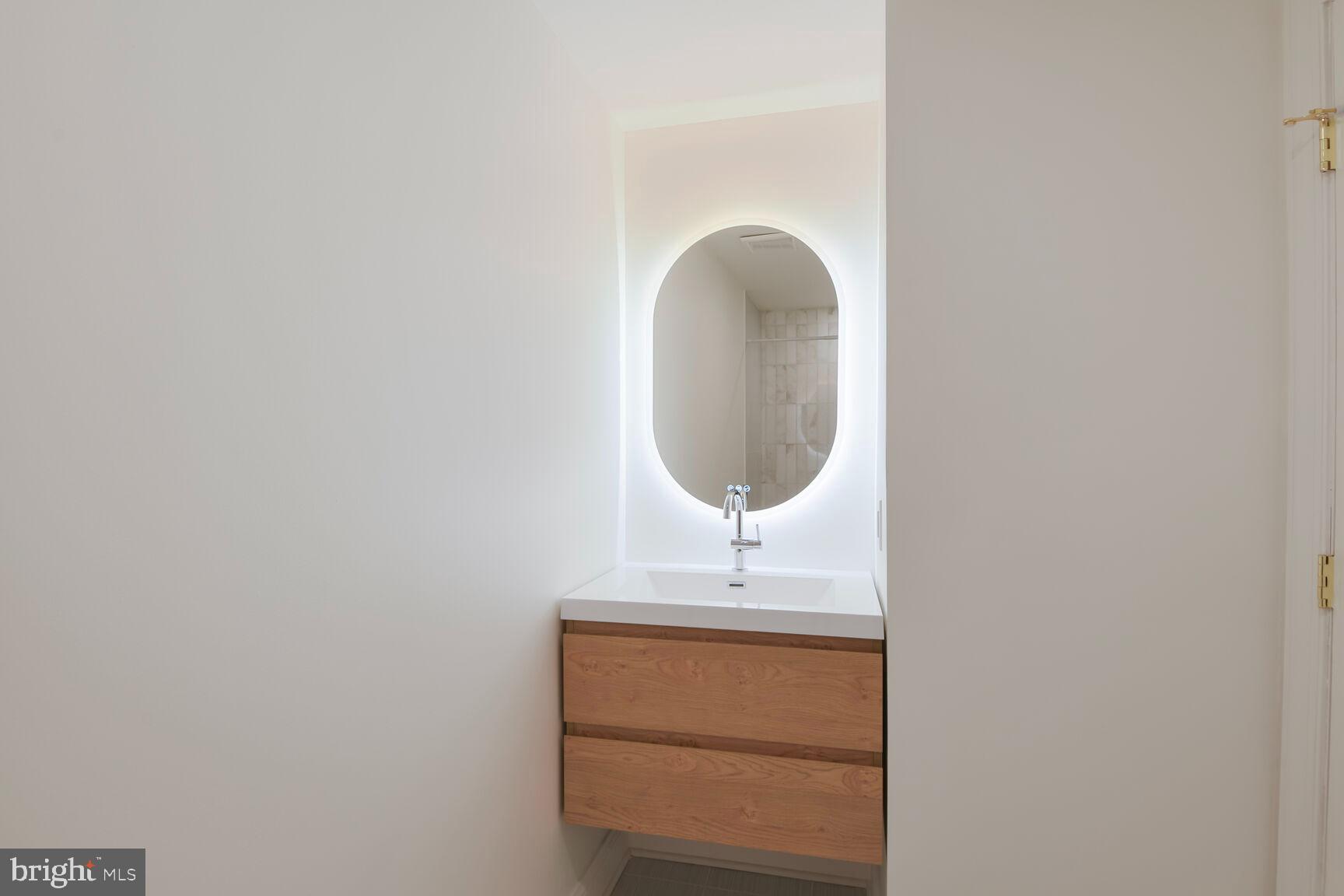 1351 Wisconsin Avenue Northwest, Unit 2B Washington, DC 20007 - Photo 19 of 20 a bathroom with a sink and a mirror