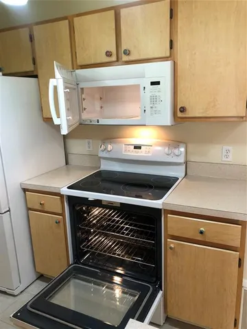 a stove top oven sitting inside of a kitchen