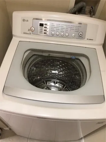 a walk in closet with wooden floor