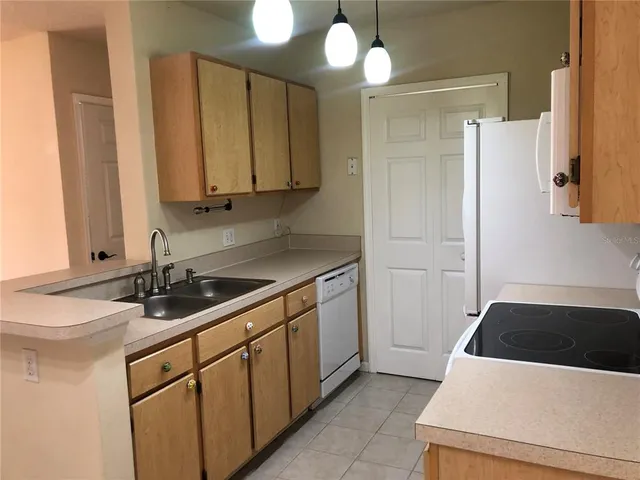 a kitchen with a sink and a refrigerator