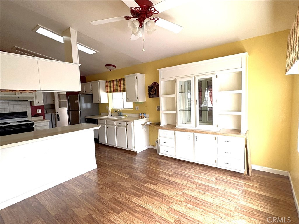 5813 Pacific Heights Road, Unit 126 Oroville, CA 95965 - Photo 11 of 59 a large white kitchen with cabinets a sink and a stove