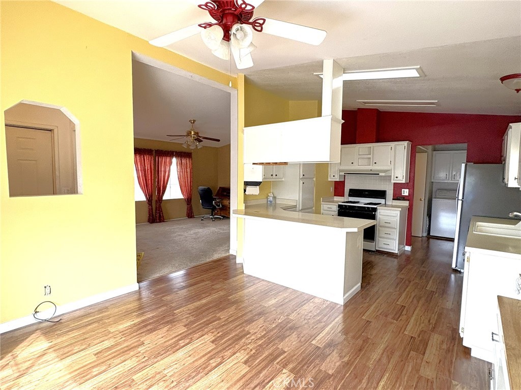 5813 Pacific Heights Road, Unit 126 Oroville, CA 95965 - Photo 4 of 59 a kitchen with stainless steel appliances kitchen island granite countertop a refrigerator a sink and a stove