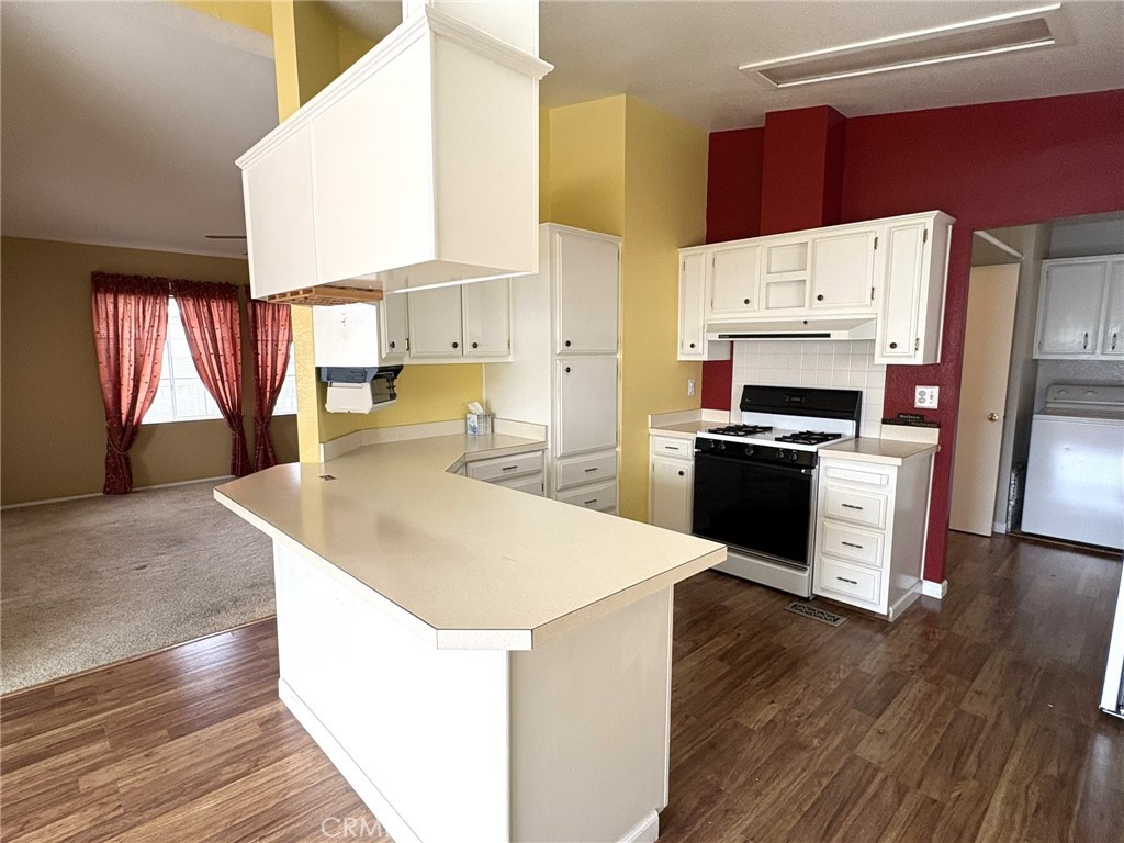 5813 Pacific Heights Road, Unit 126 Oroville, CA 95965 - Photo 7 of 59 a kitchen with stainless steel appliances a stove a sink a refrigerator white cabinets and wooden floor