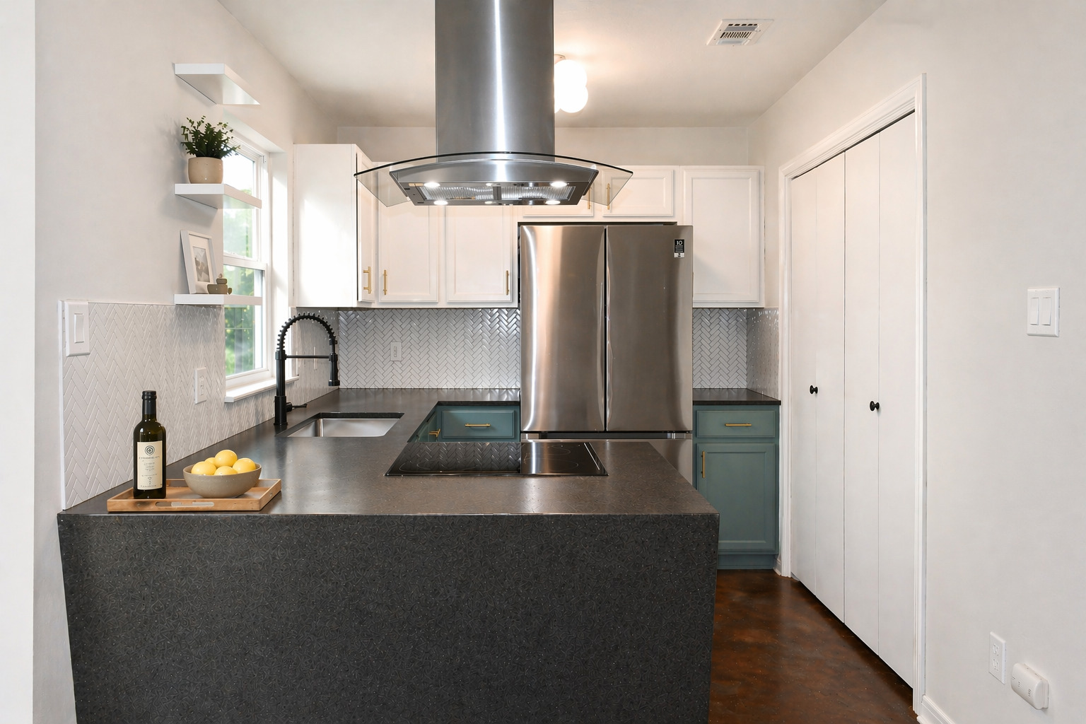 7206 Meador Avenue, Unit B Austin, TX 78752 - Photo 1 of 19 Modern kitchen featuring a U-shaped countertop with an integrated sink and cooktop, white upper cabinetry, stainless steel appliances, and a herringbone pattern tile backsplash