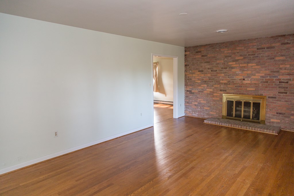 1700 Brunswick Road Waynesboro, VA 22980 - Photo 12 of 44 a view of an empty room with wooden floor and a fireplace