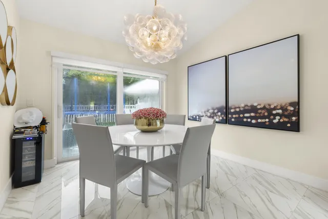 a view of a dining room with furniture and chandelier