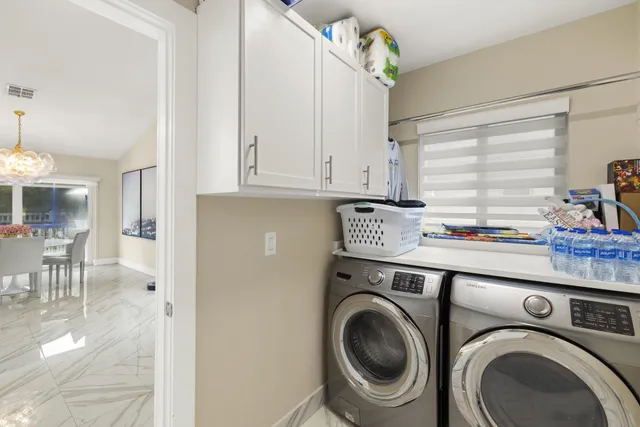 a utility room with sink dryer and washer