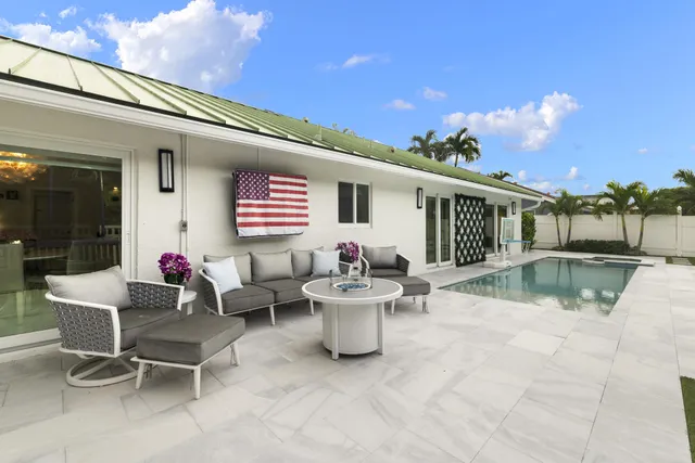 a view of a patio with a dining table and chairs with wooden fence