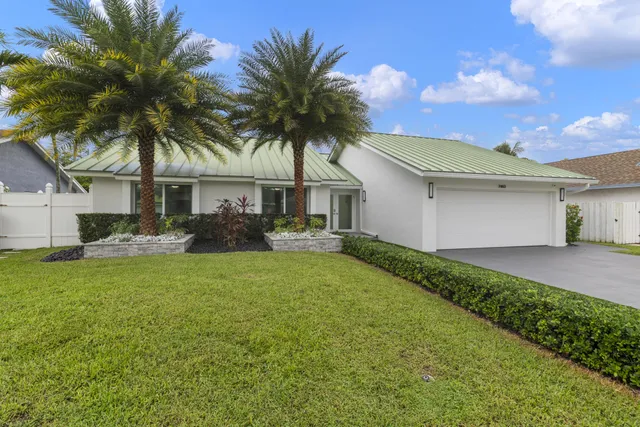 a front view of house with yard and green space