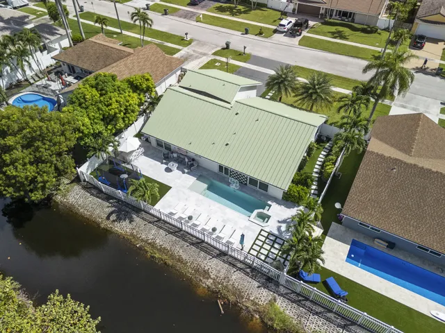 an aerial view of a house a yard basket ball court and outdoor seating