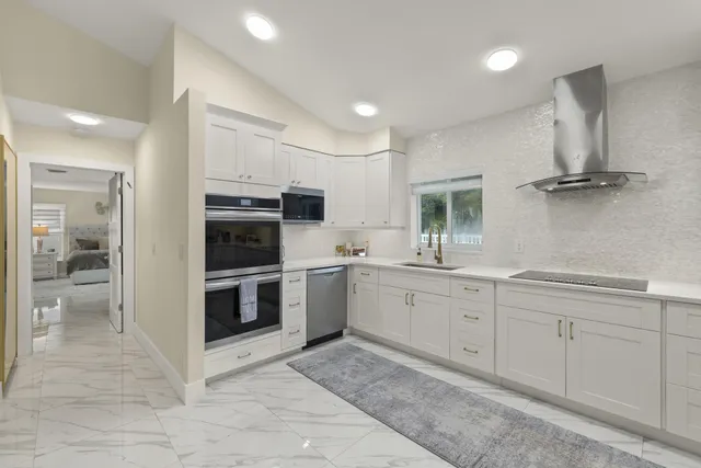 a kitchen with a sink cabinets and counter top space