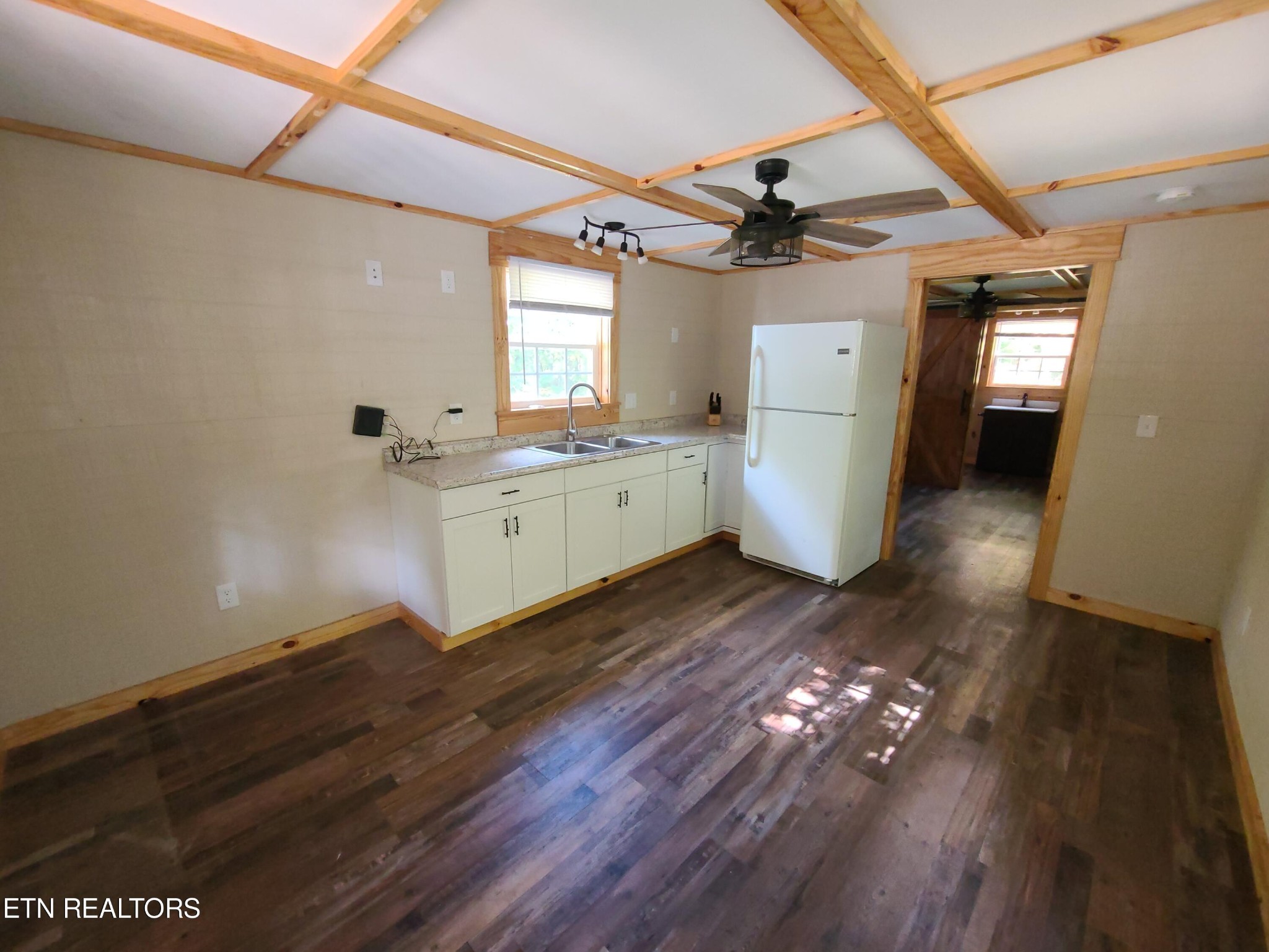 148 George Young Road Jamestown, TN 38556 - Photo 9 of 30 a kitchen with a wooden floor and white cabinets